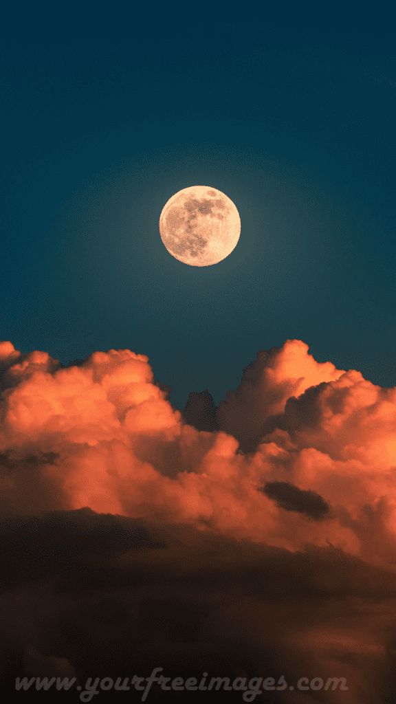 A delicate crescent moon shining brightly against a dark sky.