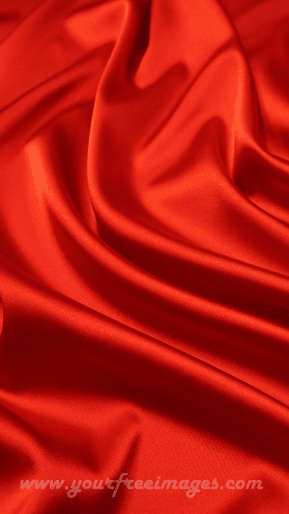 Rich red fabric draped elegantly against a black backdrop