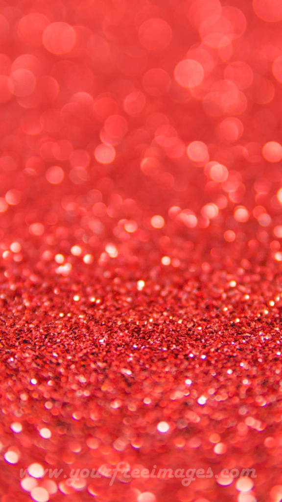Glimmering red sparkles against a deep black background
